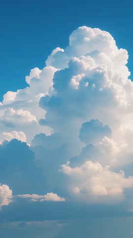 Vertical time-lapse showing towering cumulus clouds drifting and billowing in sunlit blue sky