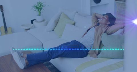 man relaxing on couch with music visuals overlay - Download Free Stock Images Pikwizard.com