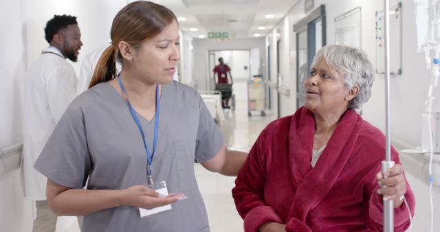 Nurse Assisting Older Patient with IV Drip in Hospital Corridor - Download Free Stock Images Pikwizard.com