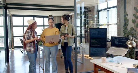 Diverse Team Collaborating on Coding Project in Modern Office