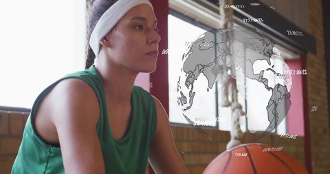 Female basketball player sitting on bench wearing headband with augmented reality globe