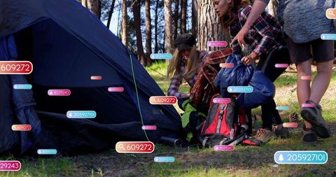 Campers in forest with augmented reality gear and blue tent