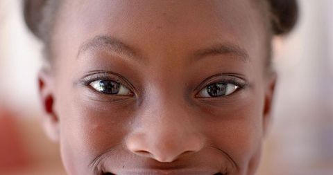 Smiling close-up portrait young african american girl with window reflection
