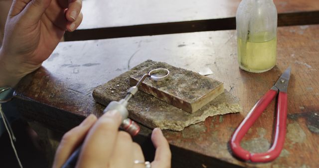 Jewelry Maker Crafting Ring Using Soldering Tool on Workbench - Download Free Stock Images Pikwizard.com