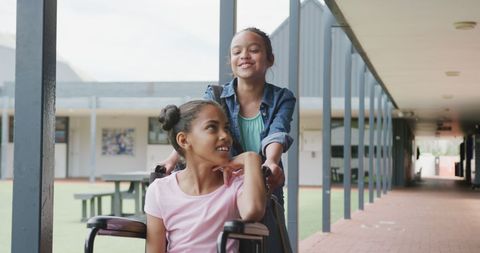 Happy Girls Enjoying Friendship in School Corridor