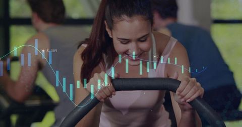 Woman gripping exercise bike while tracking fitness data with candlestick chart overlay