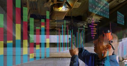 Mechanic Inspecting Vehicle Undercarriage While Analyzing Digital Diagnostics and Data