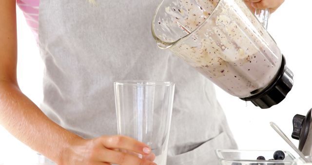 Person Pouring Blueberry Smoothie from Blender into Glass - Download Free Stock Images Pikwizard.com