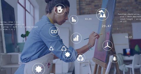 Artist Painting with Environmental Data Overlays in Studio