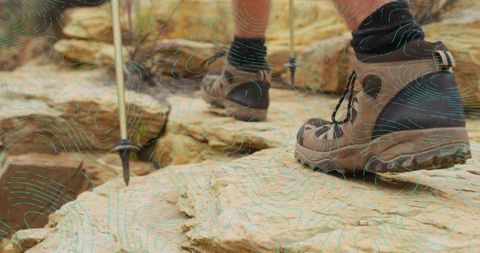 Hiker Exploring Rocky Terrain with Hiking Gear and Pole
