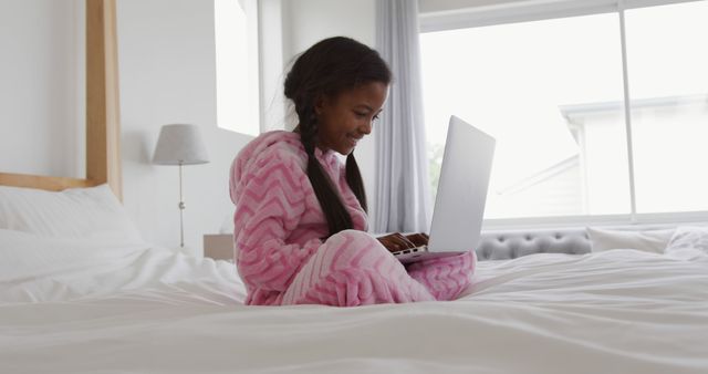 Young Girl in Pink Pajamas Using Laptop on Bed - Download Free Stock Images Pikwizard.com