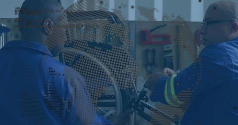 Technicians repairing bicycle wheel in mechanic workshop