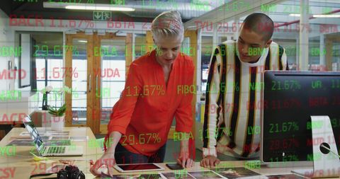 Diverse Coworkers Analyzing Stock Data in Modern Office