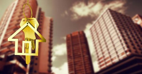 Keys to new home with urban real estate background