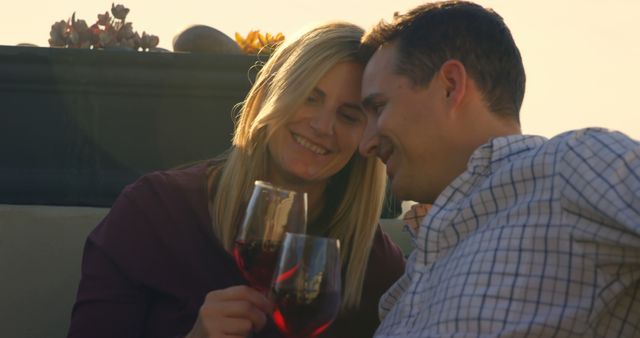 Happy couple having red wine in the balcony at home. Head to head romantic couple 4k