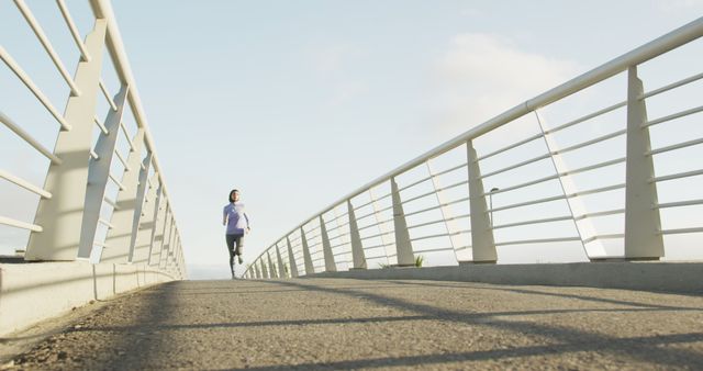 Woman Jogging on Bridge Experiencing Peaceful Morning Exercise - Download Free Stock Images Pikwizard.com