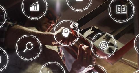 Mature Technician Tightening Bolts Wearing Safety Glasses with Augmented Reality Icons