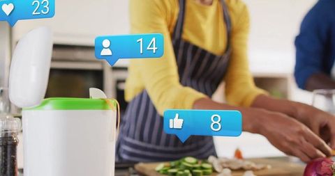 Couple Cooking Together with Social Media Icons