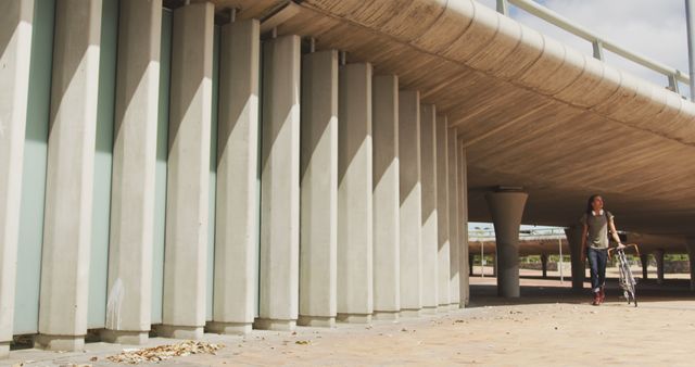 Man Walking Bicycle on Empty Urban Underpass Walkway - Download Free Stock Images Pikwizard.com