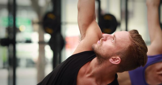 Athletic Man Practicing Yoga in Gym Focused on Stretching Pose - Download Free Stock Images Pikwizard.com