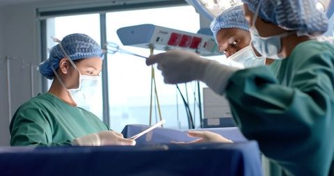 Diverse Surgeons Collaborating in Operating Theater