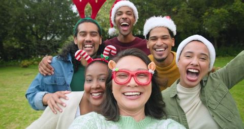 Diverse Friends Enjoy Festive Outdoor Selfie in Winter Accessories