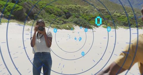 Woman on Beach Using Camera with Digital HUD Display