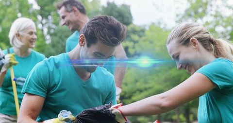 Happy Volunteers Picking Up Litter in Park