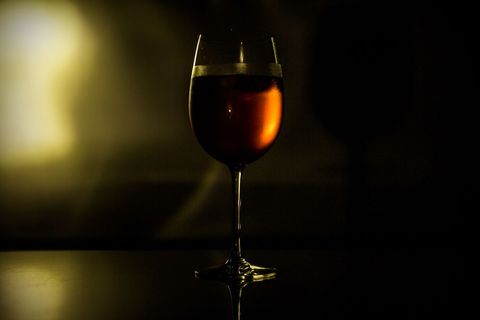 Elegant Red Wine Glass Under Moody Lighting