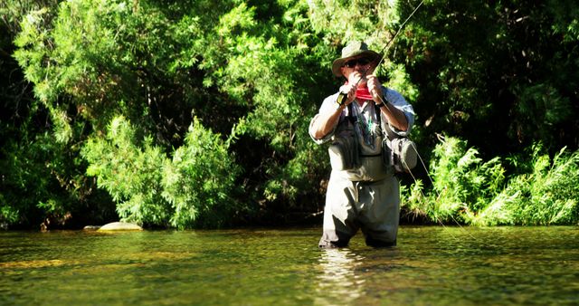Man Fly Fishing in River Wearing Fishing Gear on Sunny Day - Download Free Stock Images Pikwizard.com