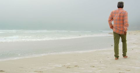 Senior African American Male Walking Alone on Misty Beach - Download Free Stock Images Pikwizard.com