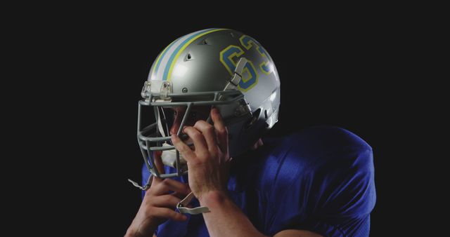 Football Player Adjusting Helmet Prepares for Game - Download Free Stock Images Pikwizard.com