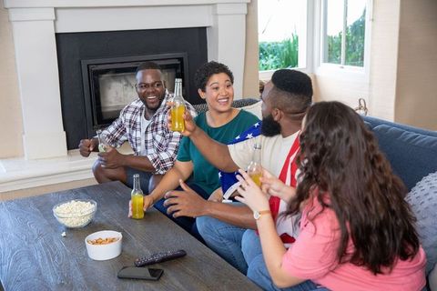 Diverse Friends Celebrating with Drinks in Cozy Living Room Setting