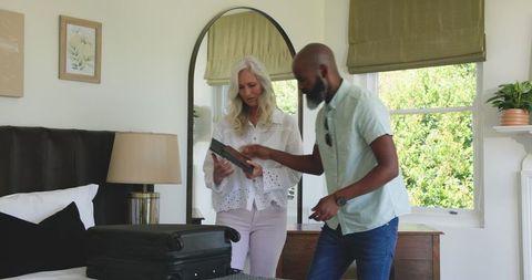 Couple Preparing Luggage in Modern Bedroom for Wedding Celebration