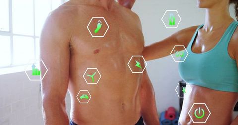 Couple training in gym with smart fitness hud monitoring torso metrics