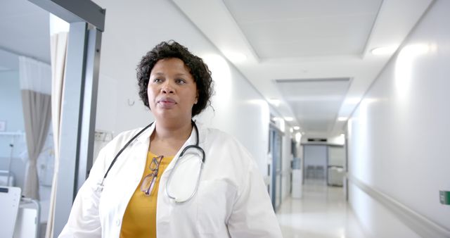 Confident Female Doctor Walking in Modern Hospital Corridor - Download Free Stock Images Pikwizard.com