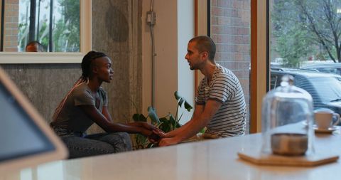 Heartfelt Conversation Between Diverse Friends in Cozy Café