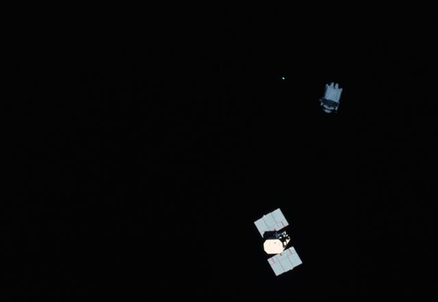 Astronaut Using MMU Near Solar Maximum Mission Satellite in Space - Download Free Stock Photos Pikwizard.com
