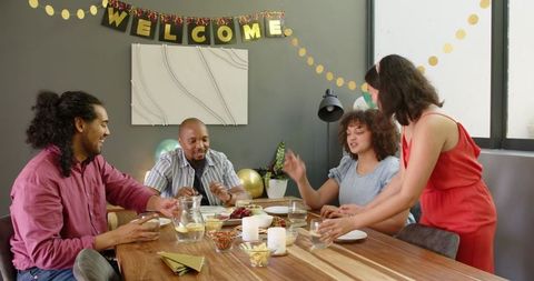 Diverse Friends Celebrating at Home Enjoying Casual Gathering