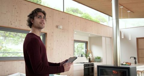 Man Engaging with Tablet in Modern Wood Crafted Home Interior