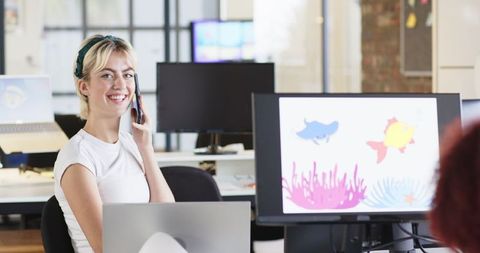 Woman Collaborating in Open-Plan Office with Vibrant Digital Designs - Download Free Stock Images Pikwizard.com