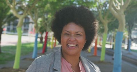 Joyful Biracial Woman Smiling in Vibrant Park