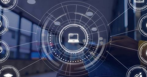 Displaying circular HUD interface with laptop icon over modern office workspace
