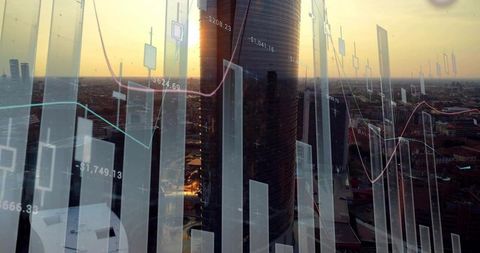 Reflecting cylindrical tower merging with financial charts over sunset city skyline