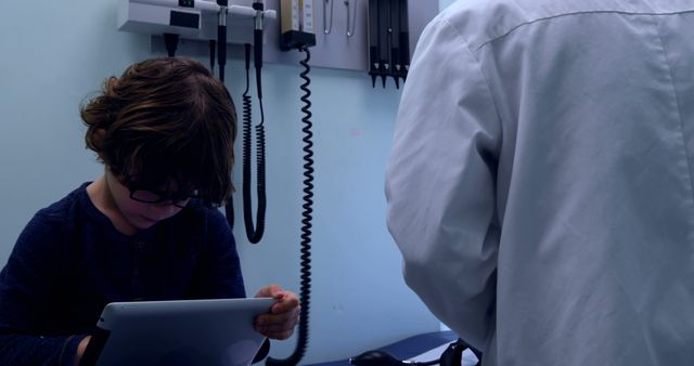 Doctor Consults Young Child Using Digital Tablet in Clinic - Download Free Stock Images Pikwizard.com