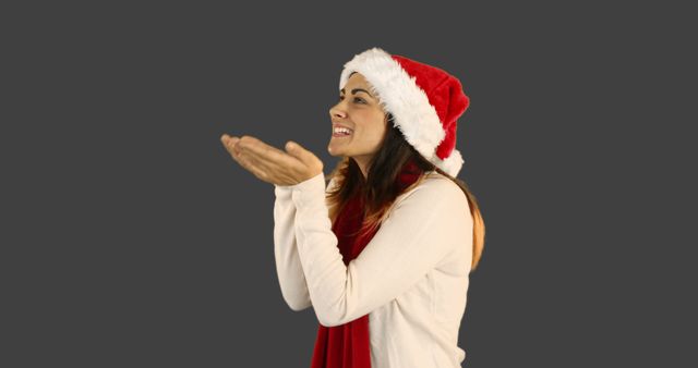 Woman in Santa Hat Blowing Kiss - Download Free Stock Images Pikwizard.com