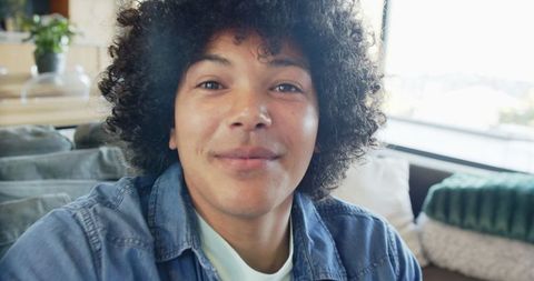 Relaxed Man Enjoying Casual Day Indoors by Sunlit Window