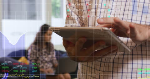 Businessman Analyzing Stock Data on Digital Tablet