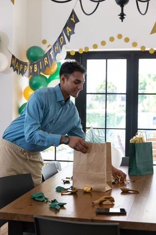 Man decorating dining table for birthday celebration