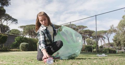 Young Girl Engaged in Environmental Clean-Up in Natural Setting